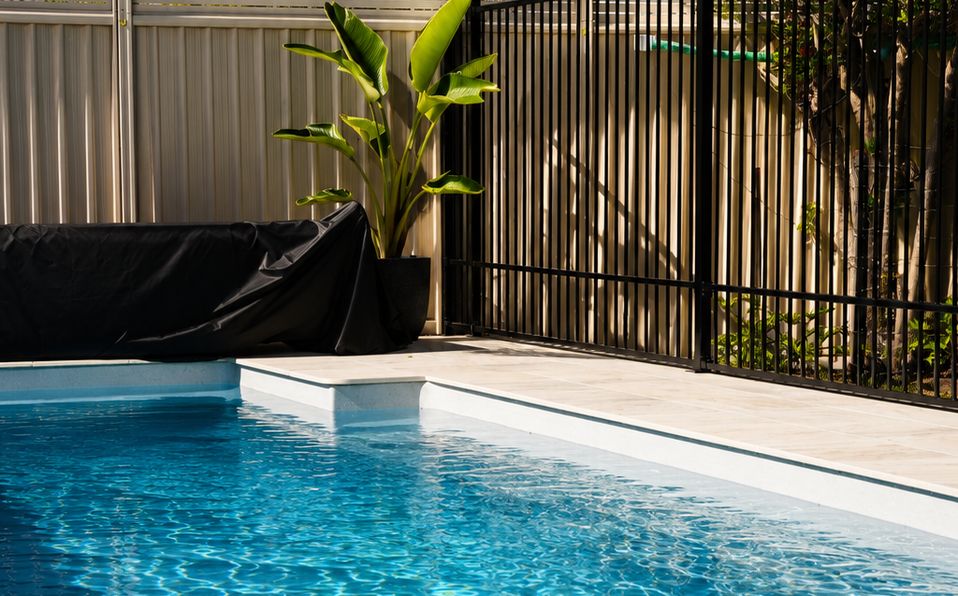 Family-sized fibreglass pool in a landscaped backyard