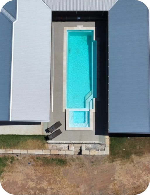 Aerial view of a fibreglass pool beside a home